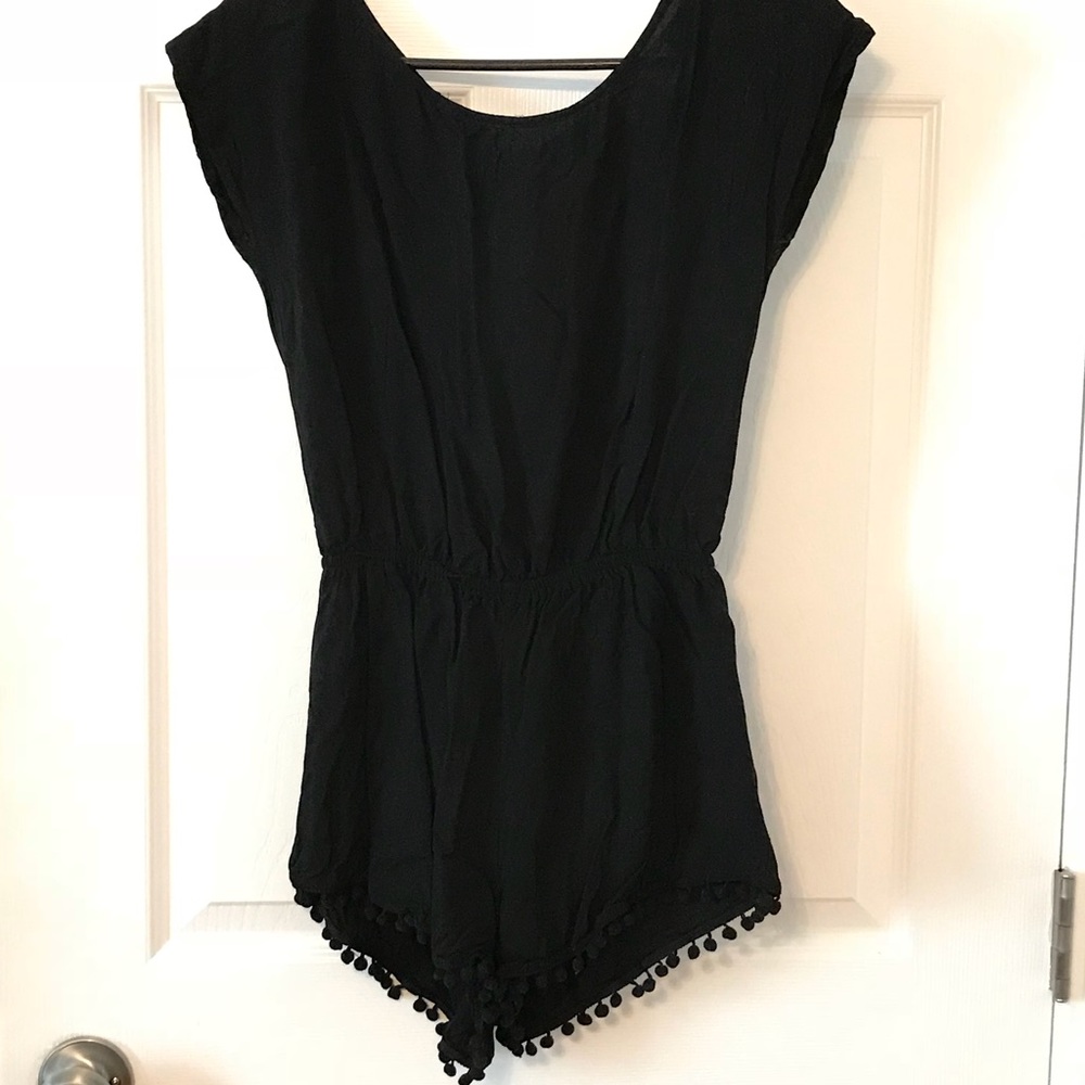 Black romper with pompom fringe & open back